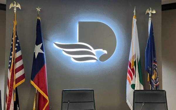 Close-up detail of a HALO-RING channel letter showing the illuminated acrylic ring and routed lighted face